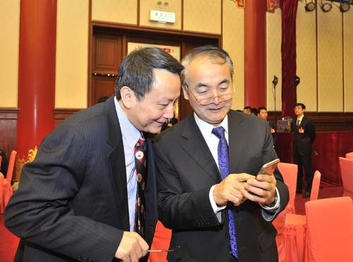 賈慶國和葛劍平相見在新年茶話會上，通過手機留影紀念2015年