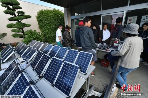 當?shù)貢r間4月17日，臨時避難所用太陽能板為災民的手機充電。