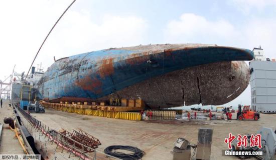 當地時間4月1日，在韓國木浦港，被打撈出水的“世越”號沉船等待被移送上岸。