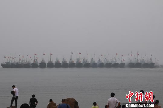 當(dāng)?shù)貪O民駕駛著掛滿紅綢的漁船開(kāi)啟祭海巡游，駛向主祭壇所在地——海上碑龍王廟。　張西竹 攝