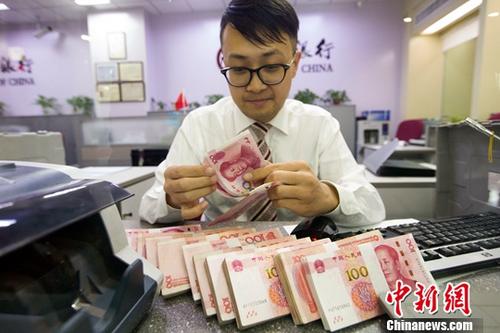 10月9日，來自中國外匯交易中心的數(shù)據(jù)顯示，人民幣對美元匯率中間價報6.6493，較前一交易日下跌124個基點(diǎn)，這也是連續(xù)6日下調(diào)。圖為7日，山西太原，銀行工作人員清點(diǎn)貨幣。<a target='_blank' href='http://www.chinanews.com/'>中新社</a>記者 張云 攝