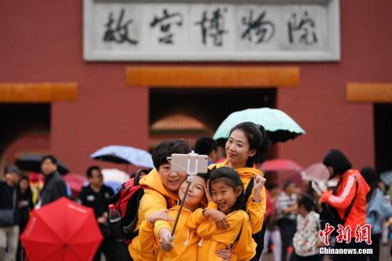 10月2日，北京小雨，游客在故宮博物院游覽。根據(jù)國家旅游局數(shù)據(jù)中心綜合測算，中國國慶假期首日，全國當天共接待游客1.13億人次，同比增長10.5%，實現(xiàn)旅游收入965億元，同比增長12.2%。<a target='_blank' href='http://www.chinanews.com/'>中新社</a>記者 杜洋 攝