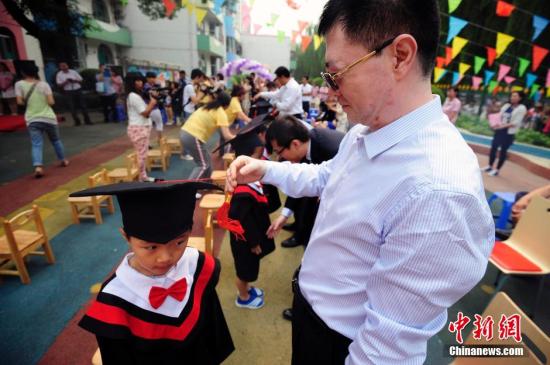 資料圖：山西太原一幼兒園的孩子們穿上學(xué)士服參加畢業(yè)典禮。<a target='_blank' href='http://www.chinanews.com/'>中新社</a>發(fā) 張?jiān)?攝