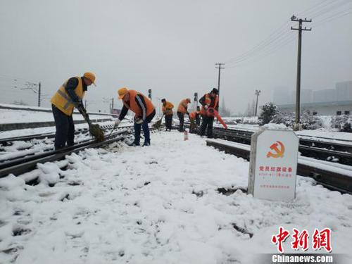 南京東車輛段貨車檢車員風(fēng)雪里按標(biāo)作業(yè)，堅(jiān)守崗位保障運(yùn)輸安全。（劉寅 攝）