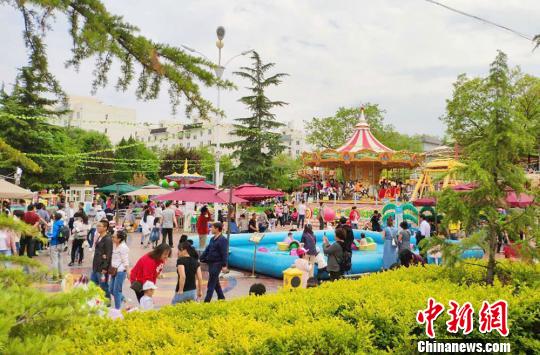 5月4日，金城公園游樂場內家長帶著孩子享受假期時光。　高展 攝